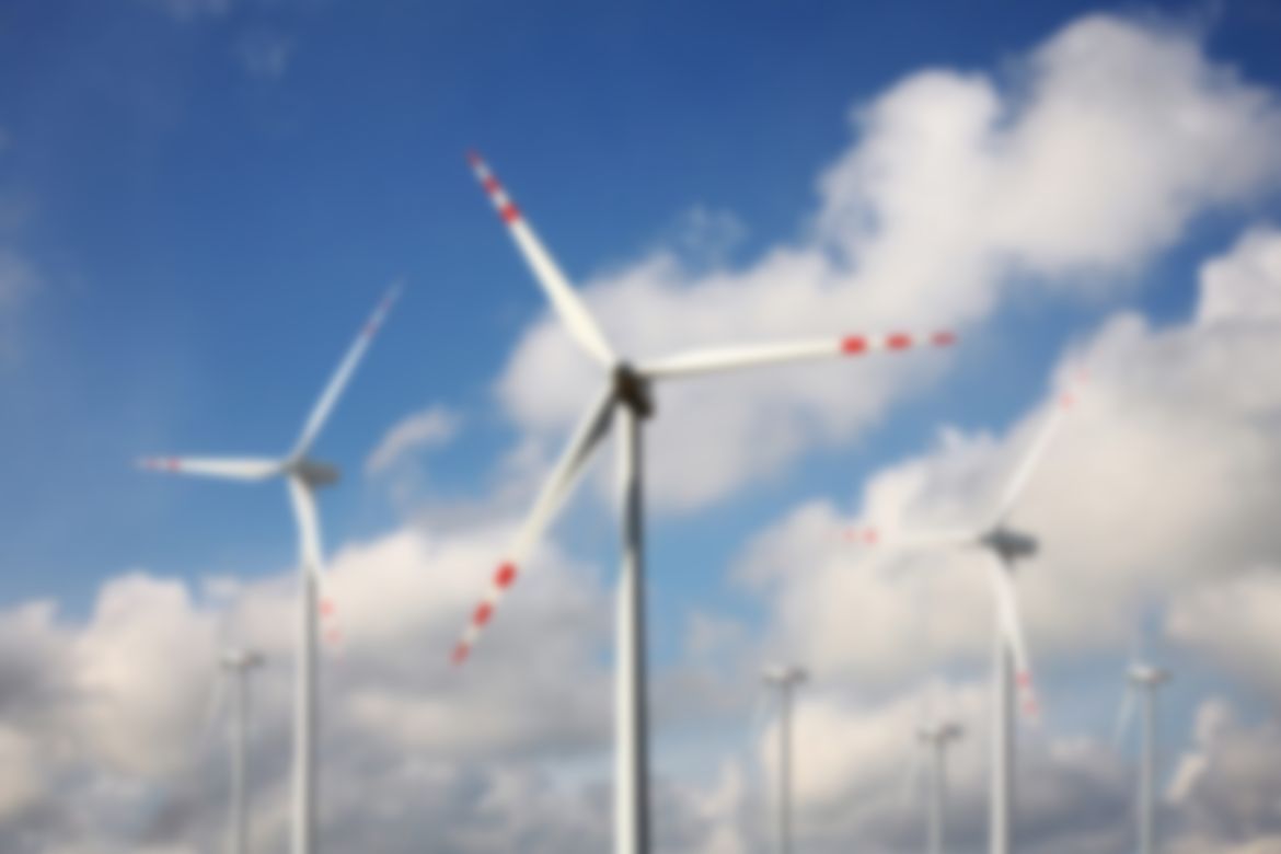 Wind power - wind turbine against the blue sky